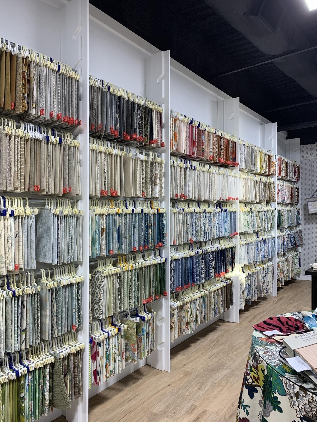 Rows of designer fabric sample books in the showroom