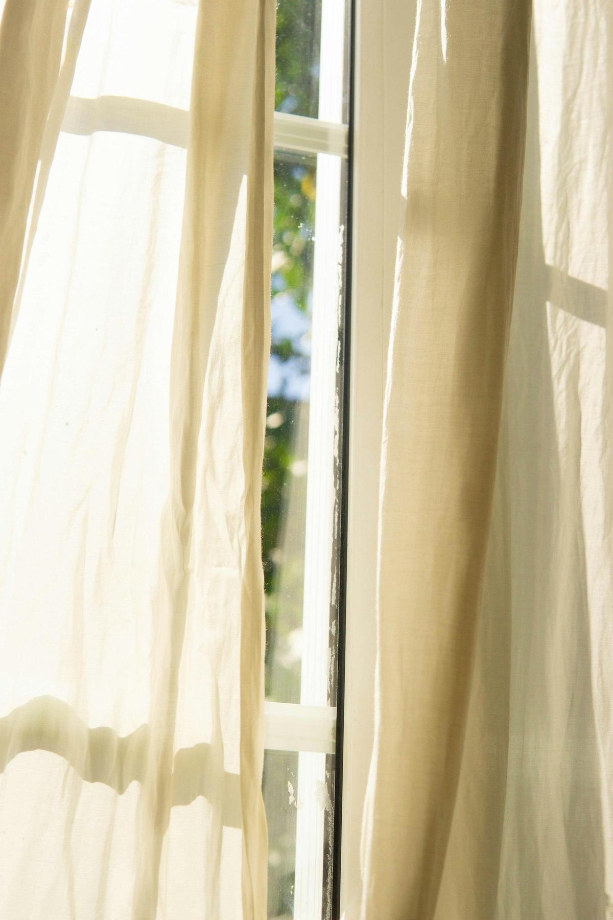 Soft light through pleated sheer drapery